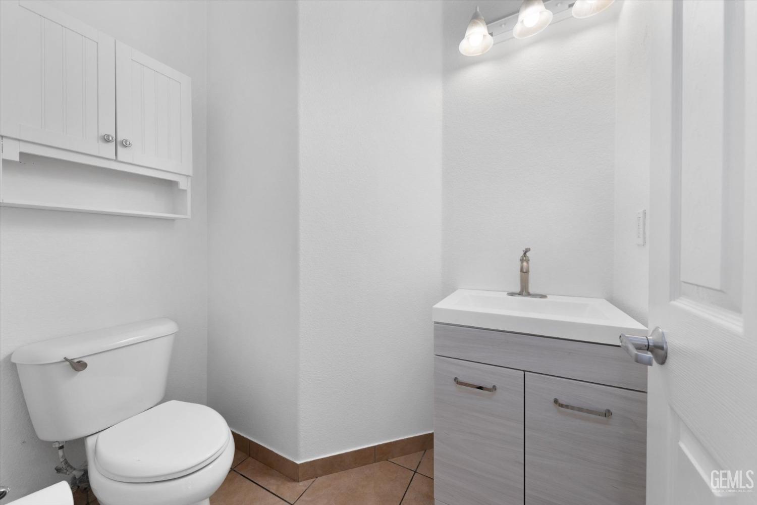 Undisclosed Address Bakersfield, CA 93313 - Photo 27 of 34 a white toilet sitting next to a bathroom sink