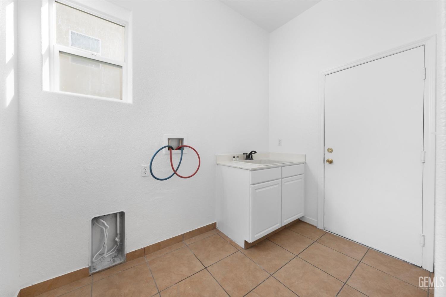 Undisclosed Address Bakersfield, CA 93313 - Photo 30 of 34 a bathroom with a granite countertop sink and a window