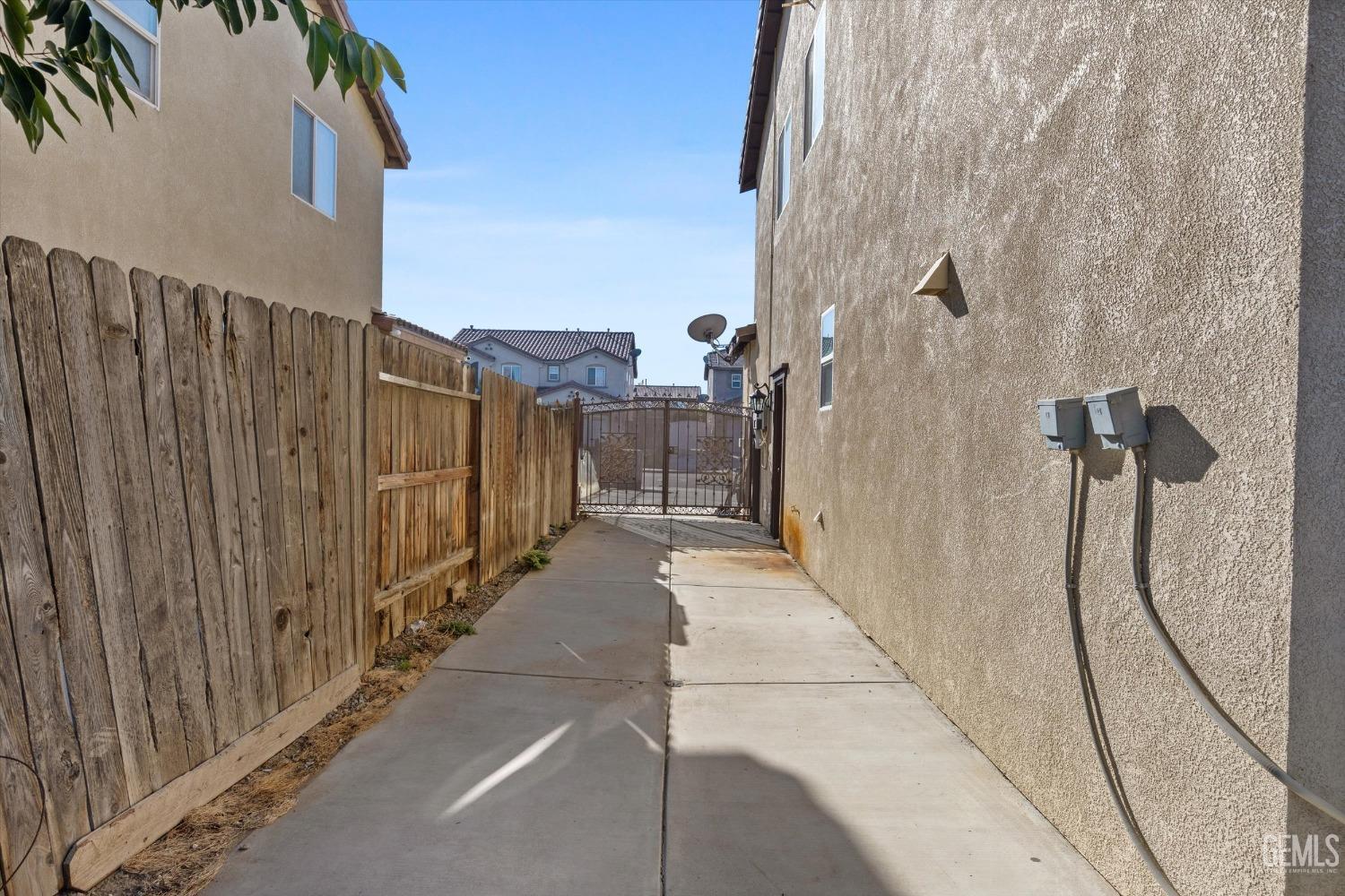 Undisclosed Address Bakersfield, CA 93313 - Photo 34 of 34 a view of a pathway along a building