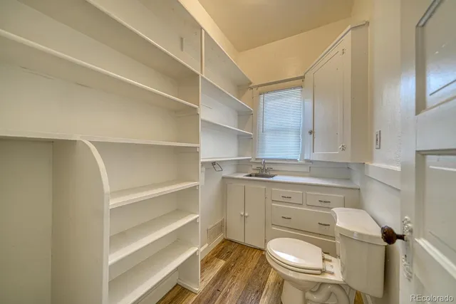 a bathroom with a toilet a sink and a mirror