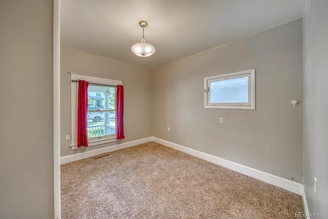 an empty room with windows and chandeliers