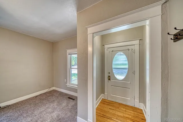 a view of walk in closet with chandelier and glass door