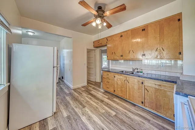 a kitchen with stainless steel appliances granite countertop a refrigerator and a sink
