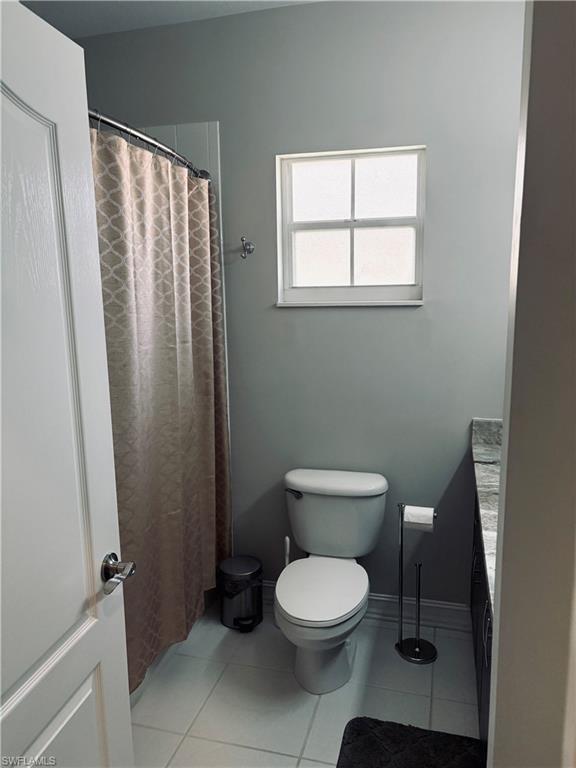 685 Luisa Lane, Unit 4 Naples, FL 34104 - Photo 11 of 25 a white toilet sitting next to a bathroom sink