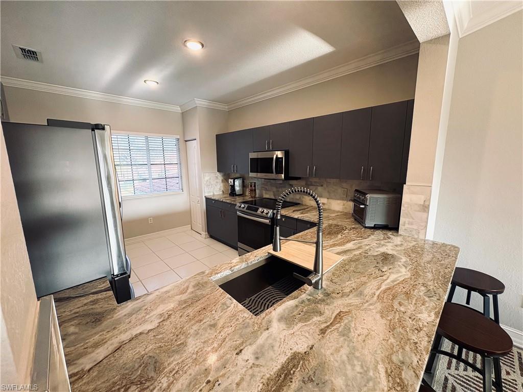 685 Luisa Lane, Unit 4 Naples, FL 34104 - Photo 16 of 25 a workspace with furniture and a window