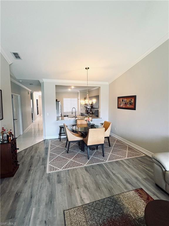 685 Luisa Lane, Unit 4 Naples, FL 34104 - Photo 17 of 25 a living room with furniture and a wooden floor