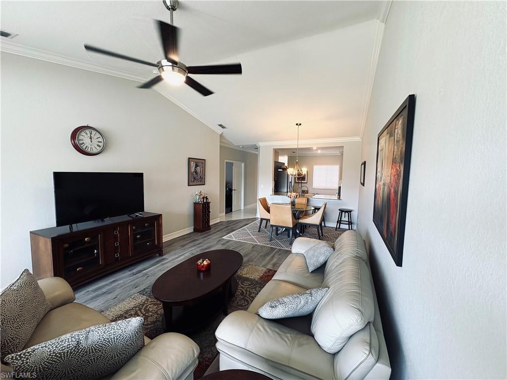 685 Luisa Lane, Unit 4 Naples, FL 34104 - Photo 19 of 25 a living room with furniture and a flat screen tv