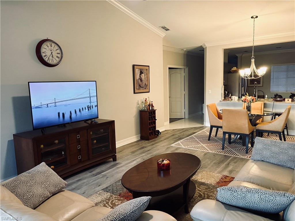 685 Luisa Lane, Unit 4 Naples, FL 34104 - Photo 20 of 25 a living room with furniture and a wooden floor