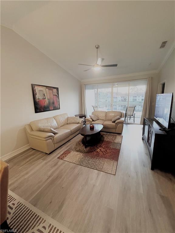 685 Luisa Lane, Unit 4 Naples, FL 34104 - Photo 21 of 25 a living room with furniture a lamp and a flat screen tv
