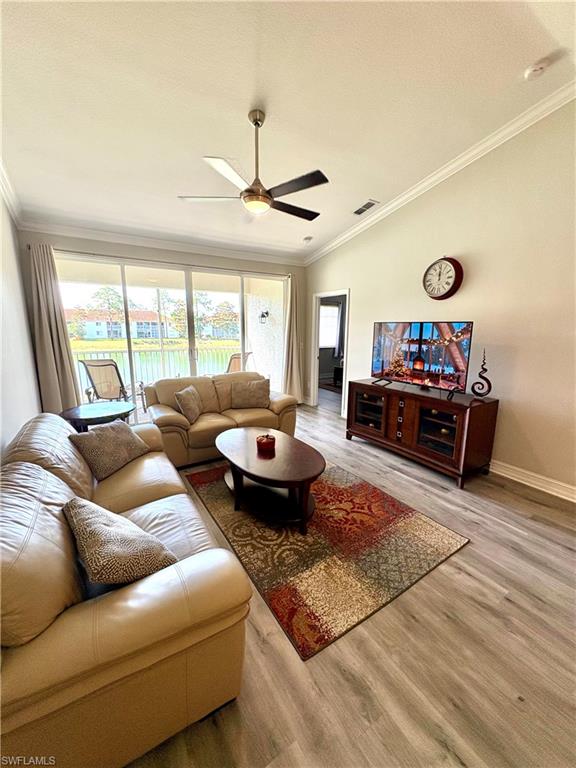 685 Luisa Lane, Unit 4 Naples, FL 34104 - Photo 22 of 25 a living room with furniture fireplace and a large window
