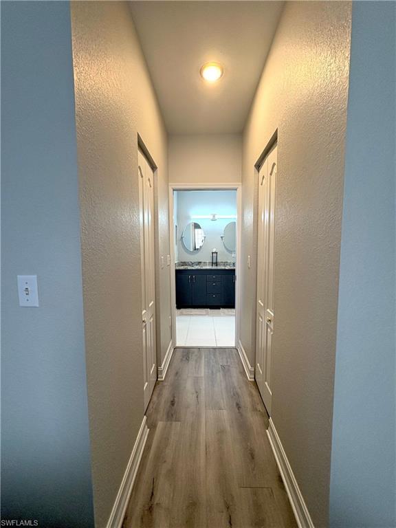 685 Luisa Lane, Unit 4 Naples, FL 34104 - Photo 6 of 25 a view of hallway with wooden floor