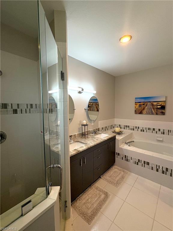 685 Luisa Lane, Unit 4 Naples, FL 34104 - Photo 8 of 25 a bathroom with a tub a sink and mirror