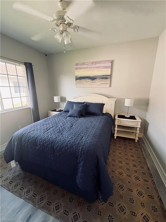 685 Luisa Lane, Unit 4 Naples, FL 34104 - Photo 9 of 25 a bedroom with a bed and window