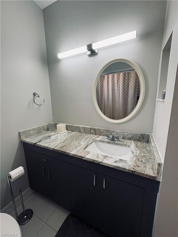 685 Luisa Lane, Unit 4 Naples, FL 34104 - Photo 10 of 25 a bathroom with a granite countertop sink and a mirror
