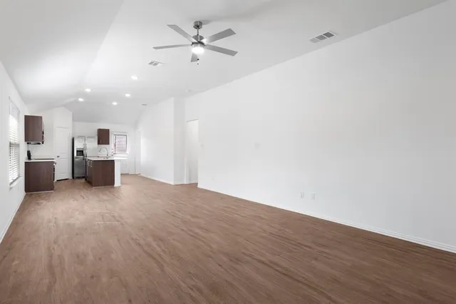 a view of a kitchen with a sink and a refrigerator