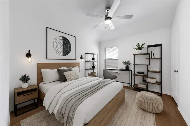 a spacious bedroom with a bed and a chandelier