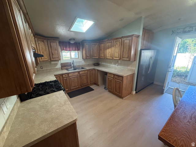 541 300 North Provo, UT 84606 - Photo 23 of 36 Kitchen featuring wood-finish cabinetry, light-toned countertops, and wood-finish flooring