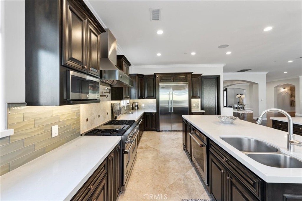 2510 Belleview Road Upland, CA 91784 - Photo 19 of 59 a large kitchen with stainless steel appliances kitchen island a large counter top a stove and a sink