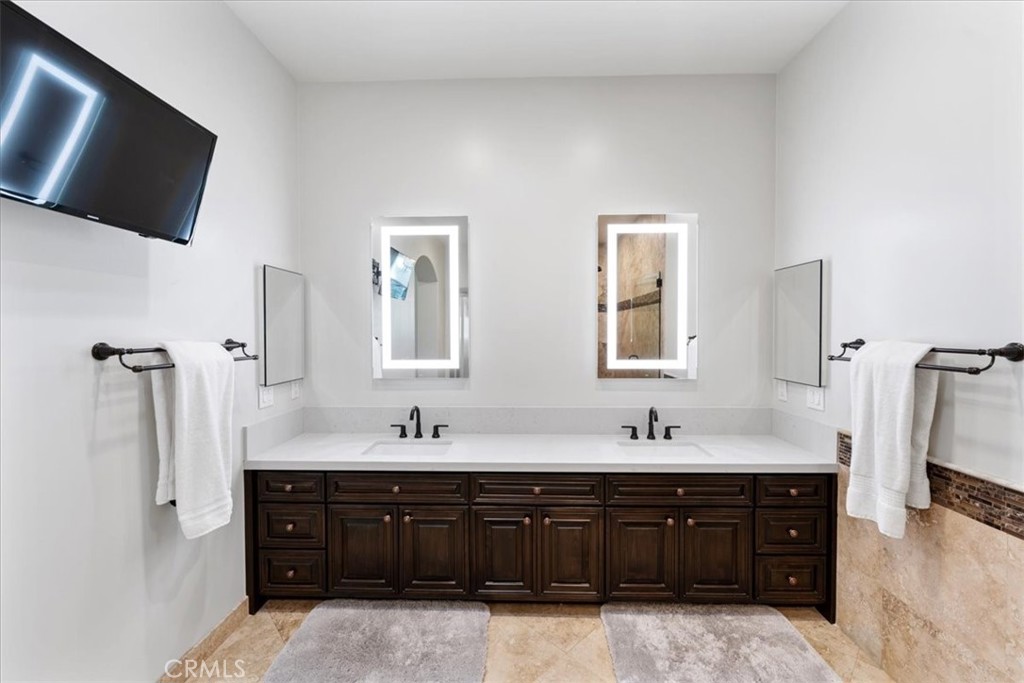 2510 Belleview Road Upland, CA 91784 - Photo 29 of 59 a bathroom with a double vanity sink and mirror with shower