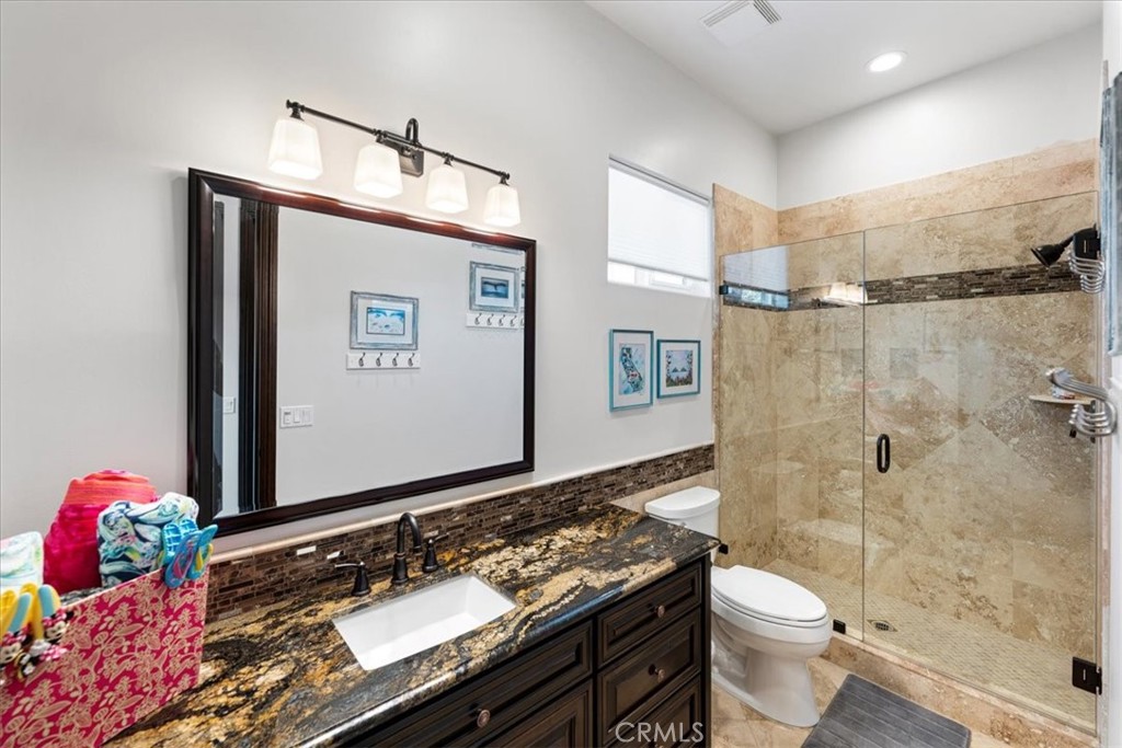 2510 Belleview Road Upland, CA 91784 - Photo 40 of 59 a bathroom with a sink vanity mirror and toilet