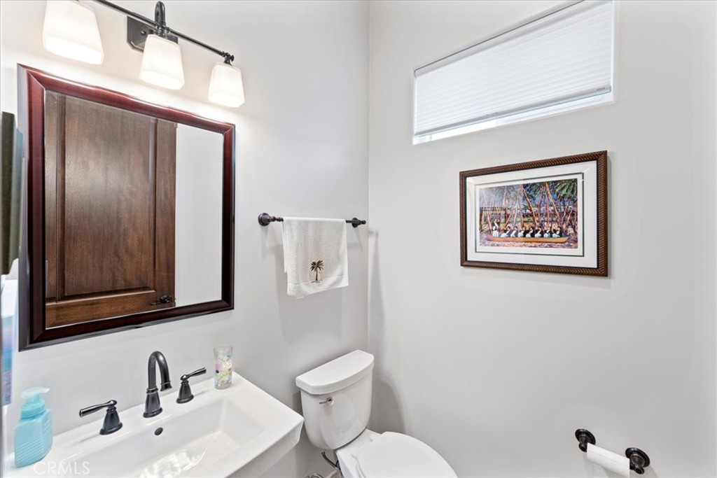 2510 Belleview Road Upland, CA 91784 - Photo 43 of 59 a bathroom with a toilet a sink and a mirror