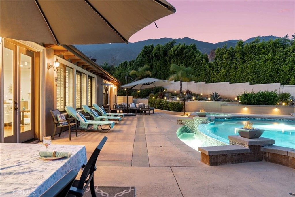 2510 Belleview Road Upland, CA 91784 - Photo 46 of 59 a view of patio with a table and chairs under an umbrella