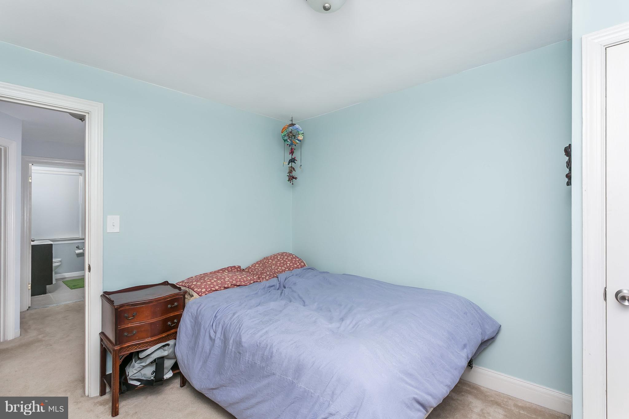 902 Andover Road Baltimore, MD 21218 - Photo 14 of 30 a bedroom with a bed and a table