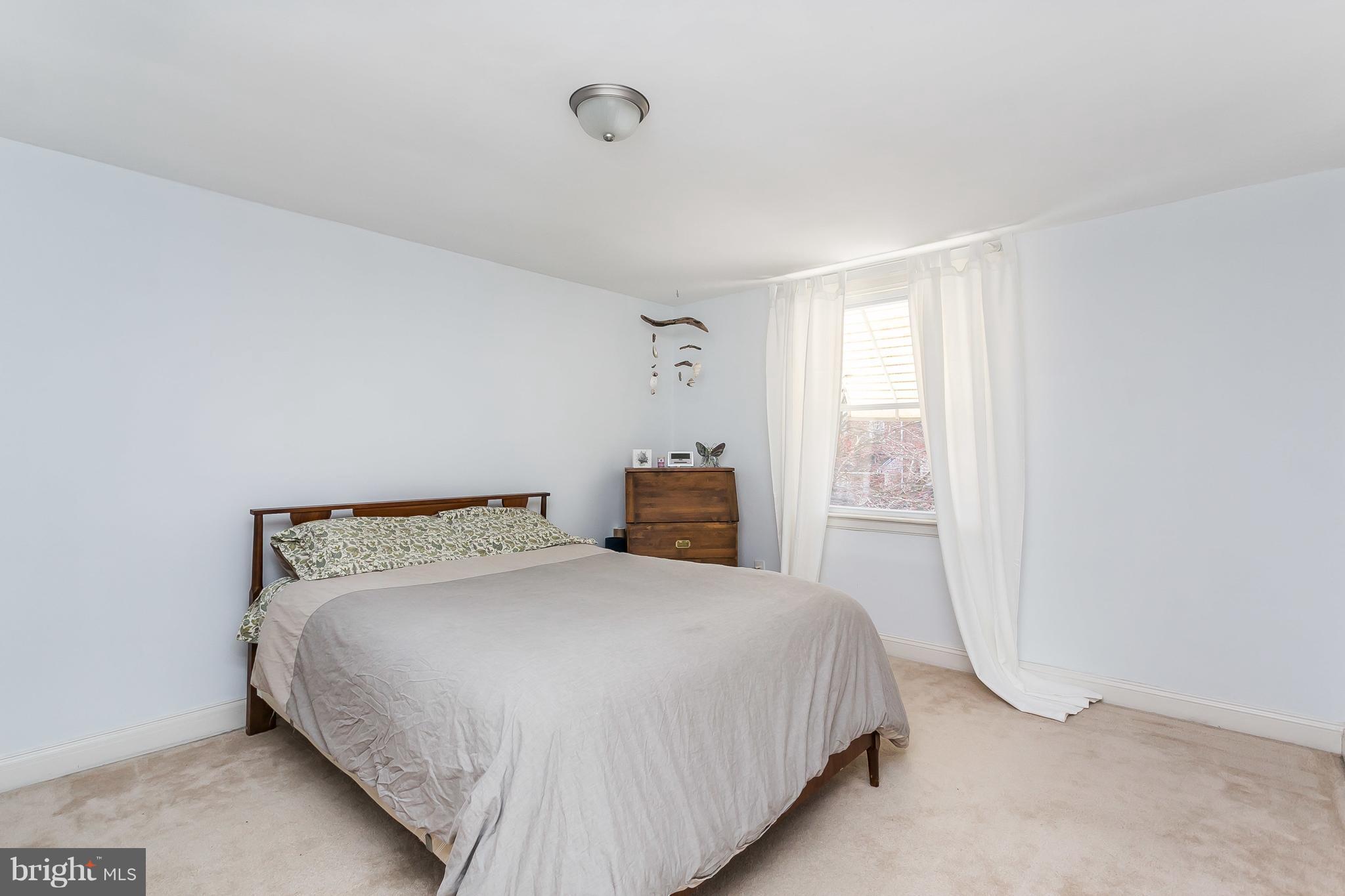 902 Andover Road Baltimore, MD 21218 - Photo 15 of 30 a bedroom with a bed and a window