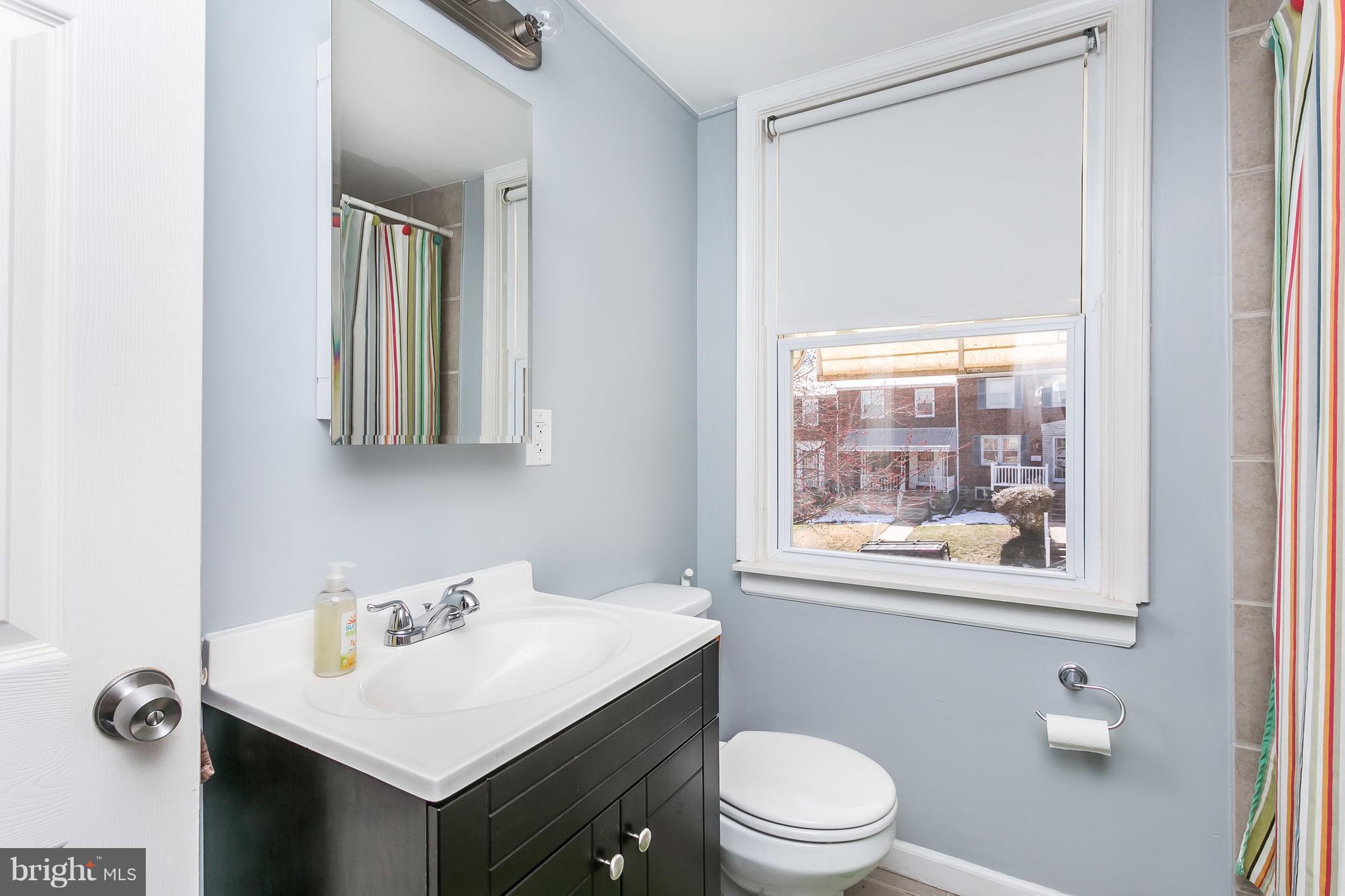 902 Andover Road Baltimore, MD 21218 - Photo 17 of 30 a bathroom with a sink vanity mirror and toilet
