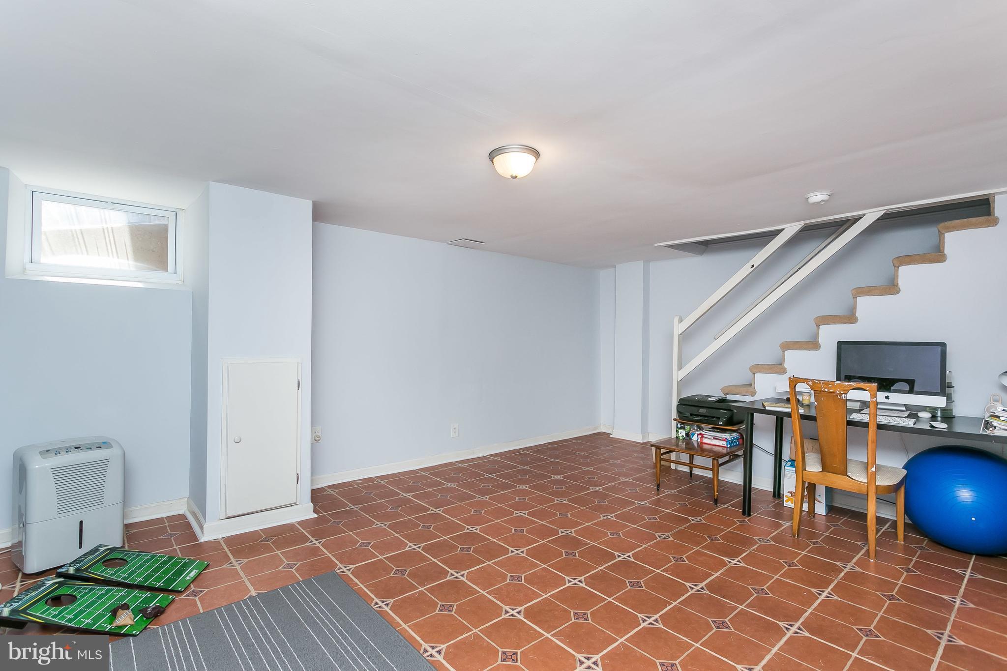 902 Andover Road Baltimore, MD 21218 - Photo 19 of 30 a room with lots of furniture and wooden floor