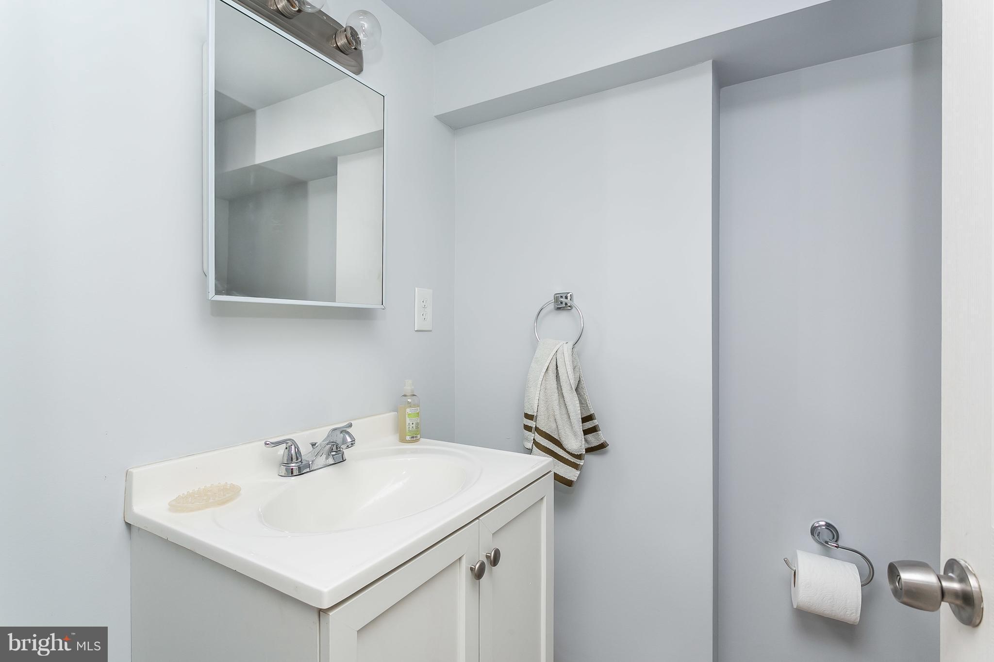 902 Andover Road Baltimore, MD 21218 - Photo 21 of 30 a bathroom with a sink and mirror