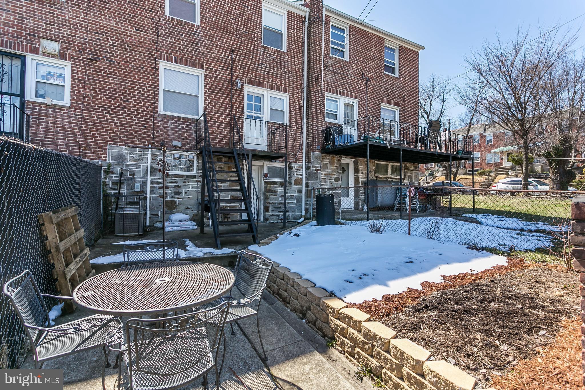 902 Andover Road Baltimore, MD 21218 - Photo 25 of 30 a backyard of a house with barbeque oven table and chairs