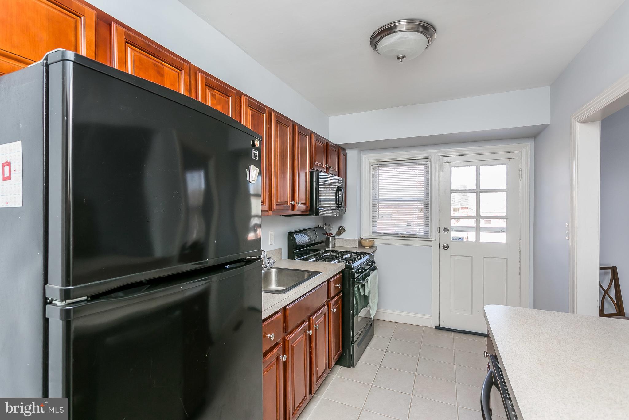 902 Andover Road Baltimore, MD 21218 - Photo 8 of 30 a kitchen with a stove a sink and a microwave
