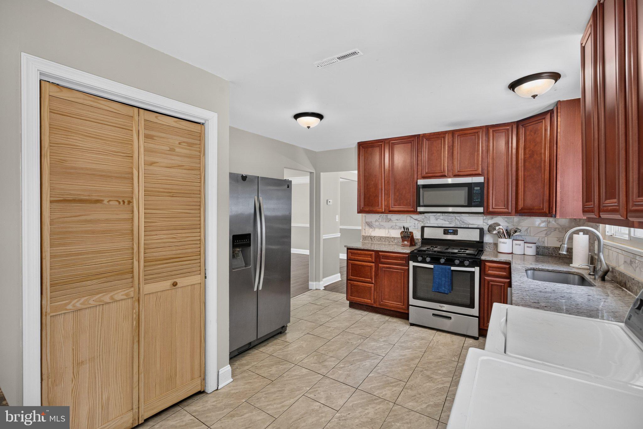 2106 North Rolling Road Windsor Mill, MD 21244 - Photo 10 of 24 Modern kitchen with warm wood accents.