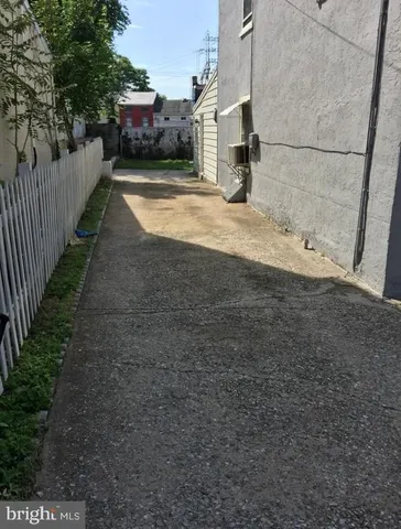 a view of a house with a snow on the road