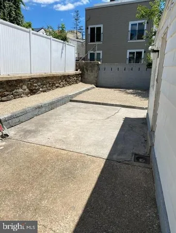 a view of a backyard with chairs potted plants