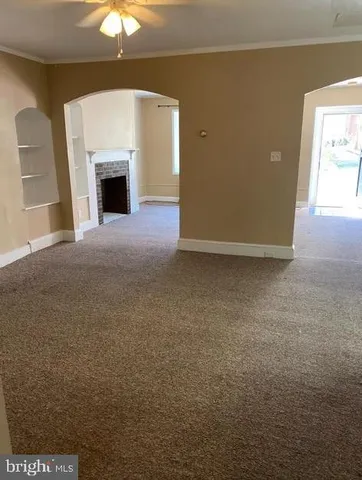 a view of empty room with a fireplace