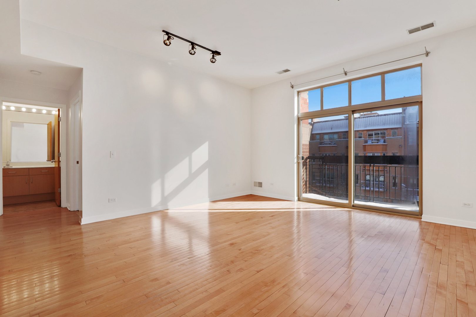 1910 South State Street, Unit 303 Chicago, IL 60616 - Photo 4 of 19 a view of an empty room with wooden floor