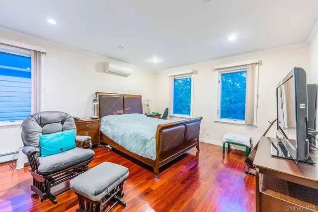 a bedroom with furniture and a wooden floor