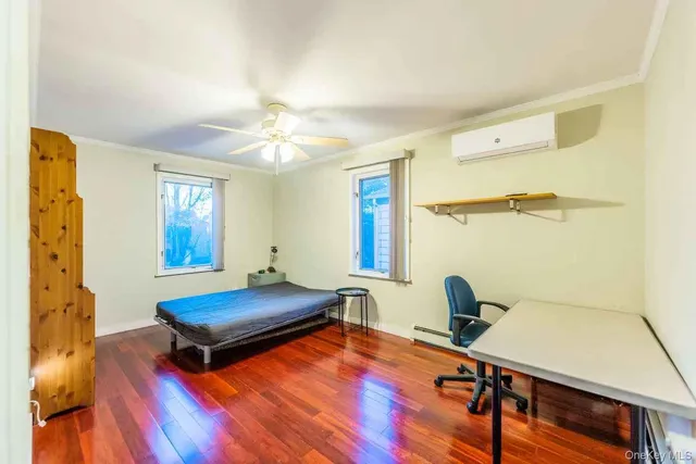 a bedroom with furniture and a window