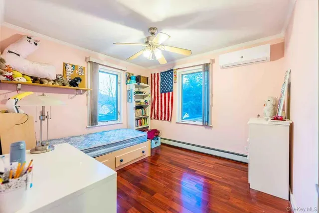 a living room with hard wood floors and a dining table
