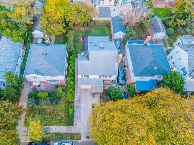 an aerial view of a house with a yard and garden