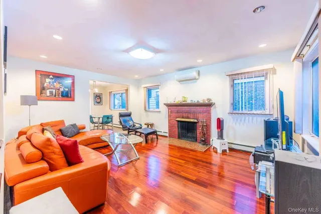 a living room with furniture a fireplace and a large window