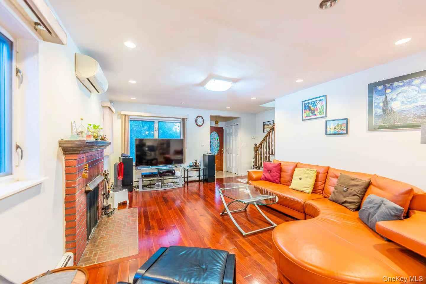 75-23 196th Street Queens, NY 11366 - Photo 4 of 26 a living room with furniture and a flat screen tv