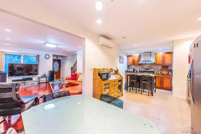 a view of a living room with furniture and a flat screen tv