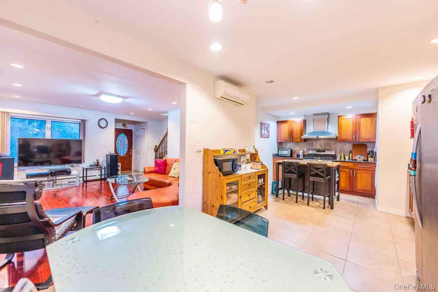 75-23 196th Street Queens, NY 11366 - Photo 5 of 26 a view of a living room with furniture and a flat screen tv