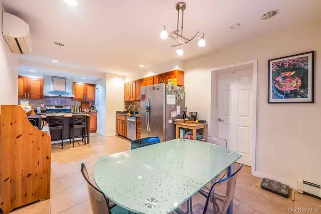 a living room with stainless steel appliances kitchen island a table and chairs