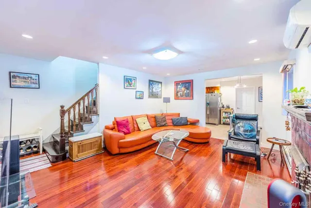 a living room with furniture and a dining table with wooden floor