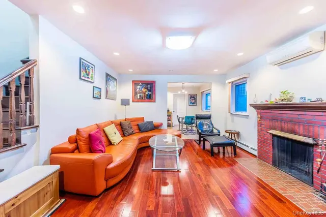 a living room with furniture fireplace and wooden floor