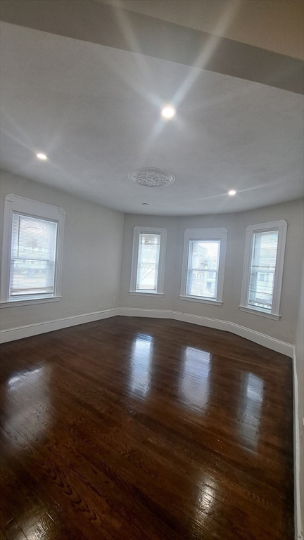 7 Samoset Street, Unit 2 Boston, MA 02124 - Photo 8 of 12 an empty room with wooden floor and windows